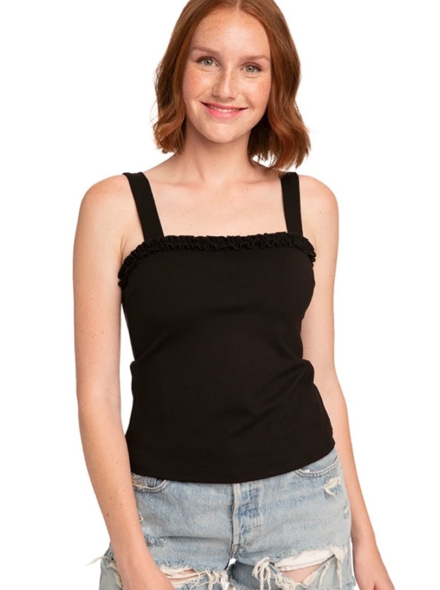 white woman in black ruffle tank top