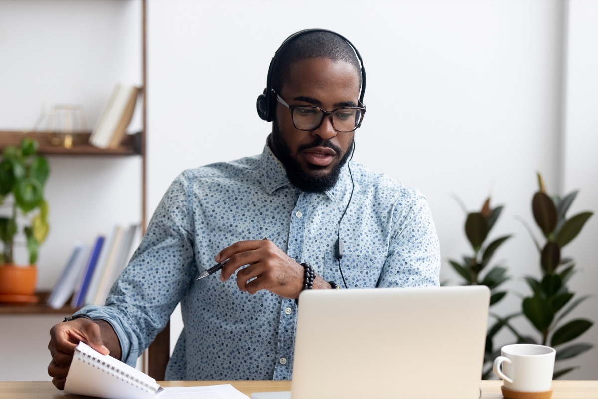 Office man working at his desk with headphones