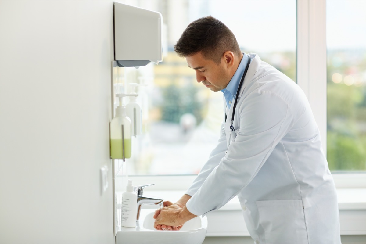 doctor washing hands at medical clinic sink