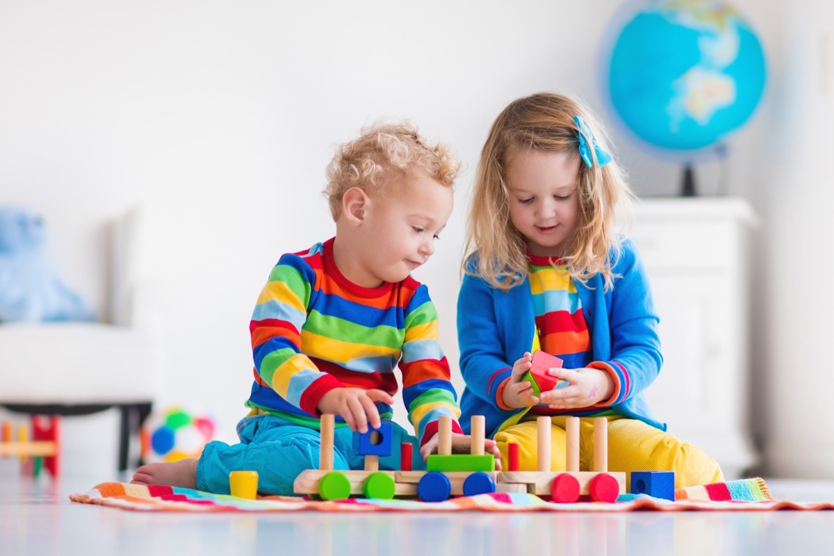 two toddlers playing with toys