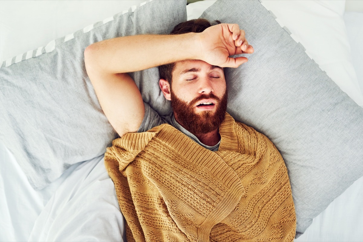 Cropped shot of a young man sleeping in his bed