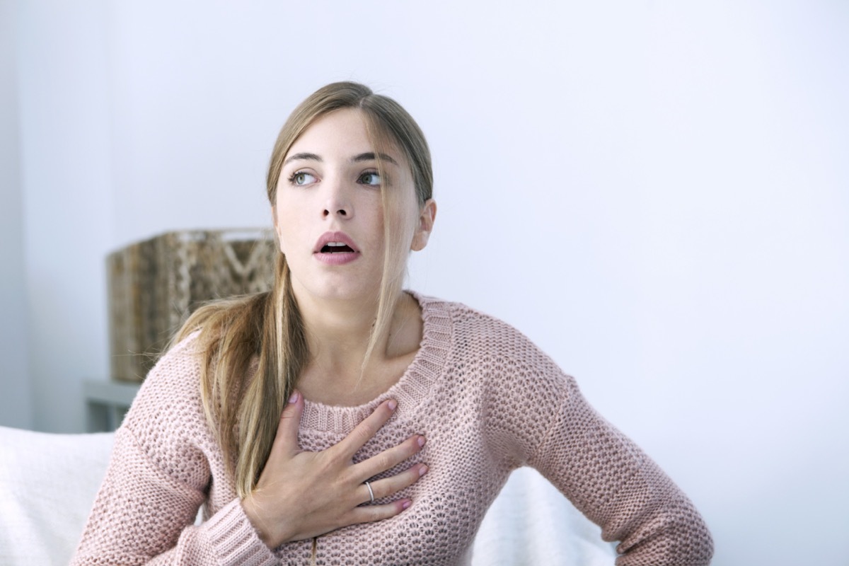 Woman pressing her chest.