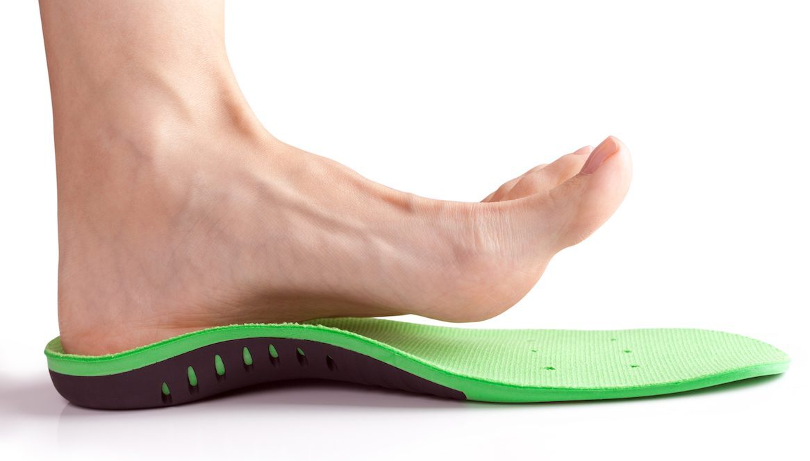 female foot stands on her heel in orthopedic insole