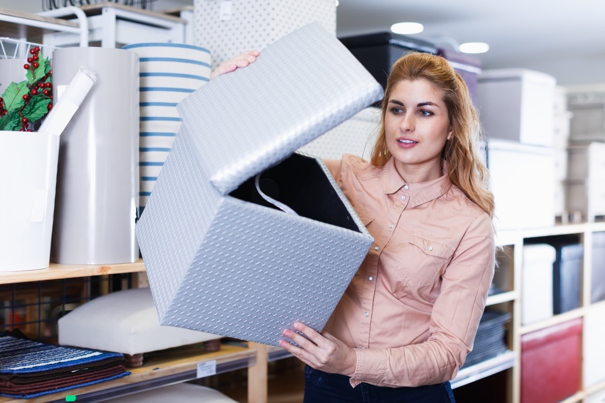 Woman looking at an ottoman with storage