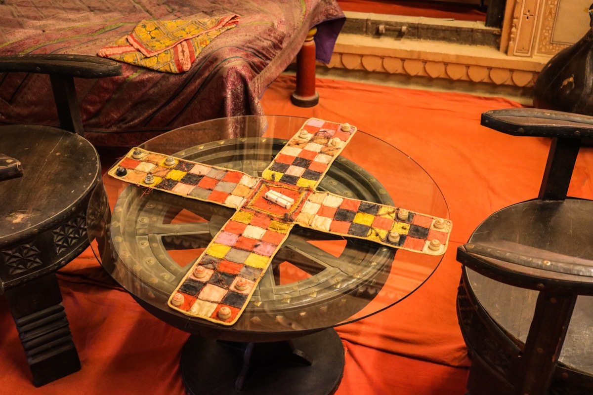 Chaupar/chopad is a cross and circle board game similar to pachisi, played in India. The game board display in Patwon Ki Haveli