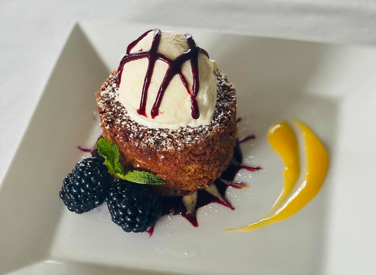 butter cake with blackberries and scoop of vanilla ice cream