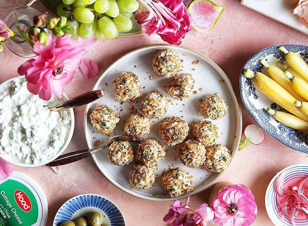 herbed cheese bites with cottage cheese on a pink table with fruit