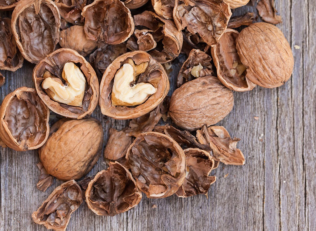 cracked walnuts on wooden table