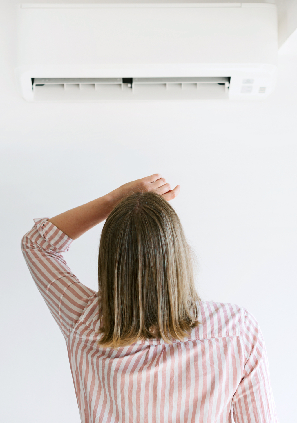 Woman with Air Conditioner, signs your home is falling apart