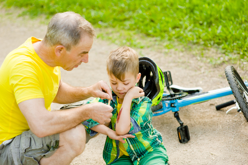 Dad putting bandaid on son