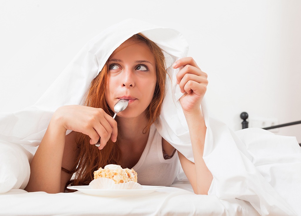 woman eating in bed