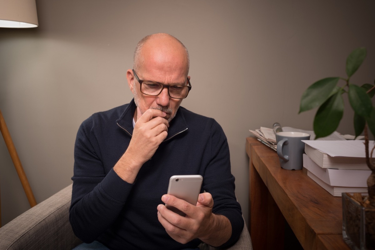 man looking concerned at phone