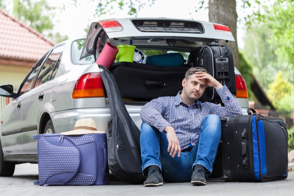 man with bags going into car