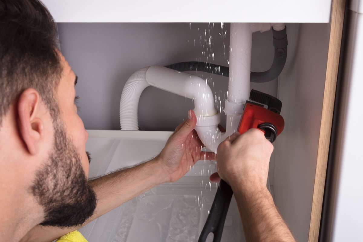 Man Repairing a Pipe