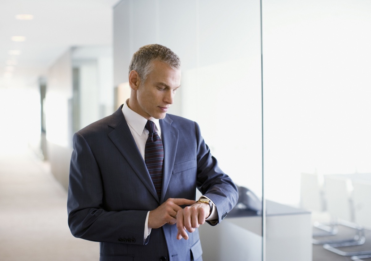 Businessman checking the time in office