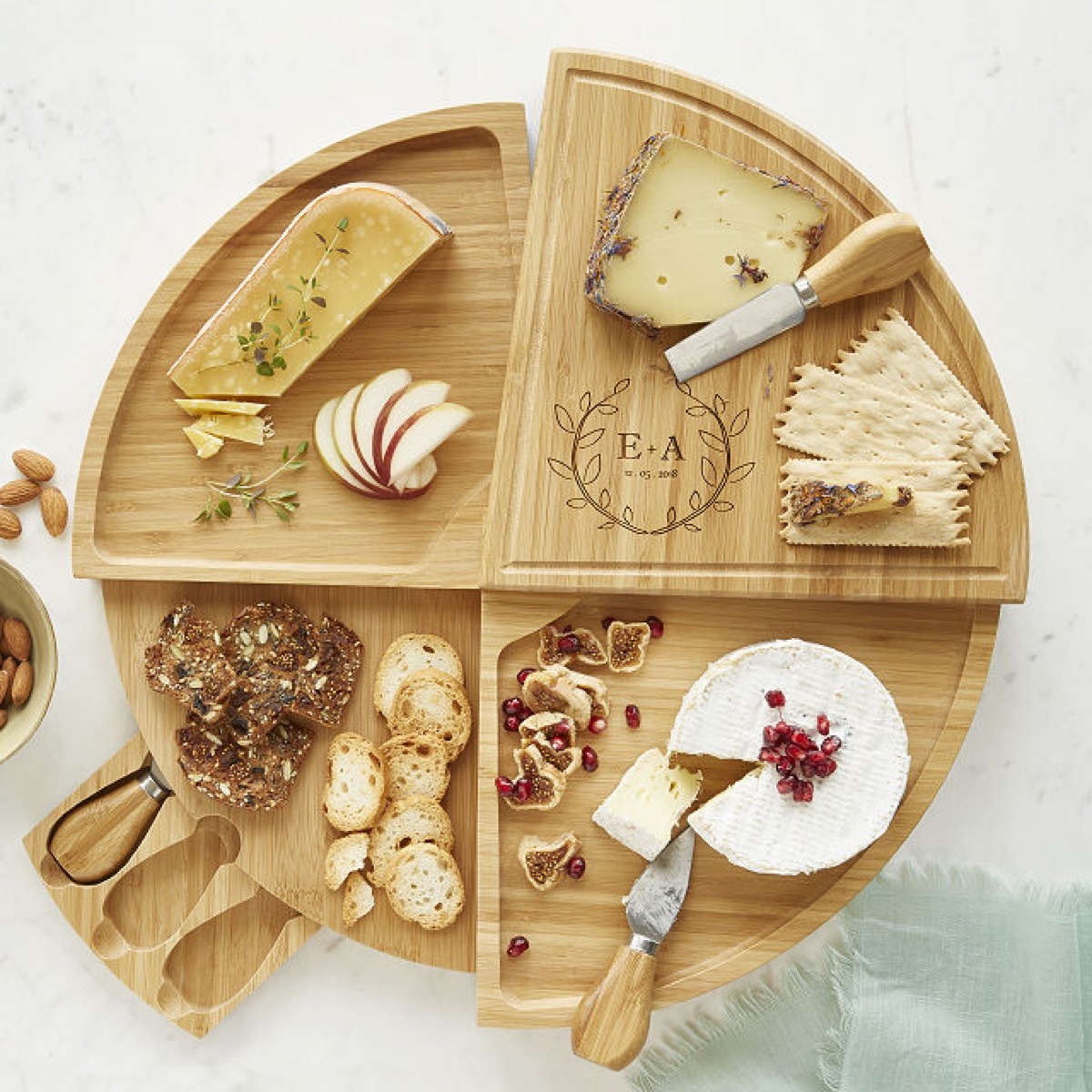 four compartment cheese board with snacks on it