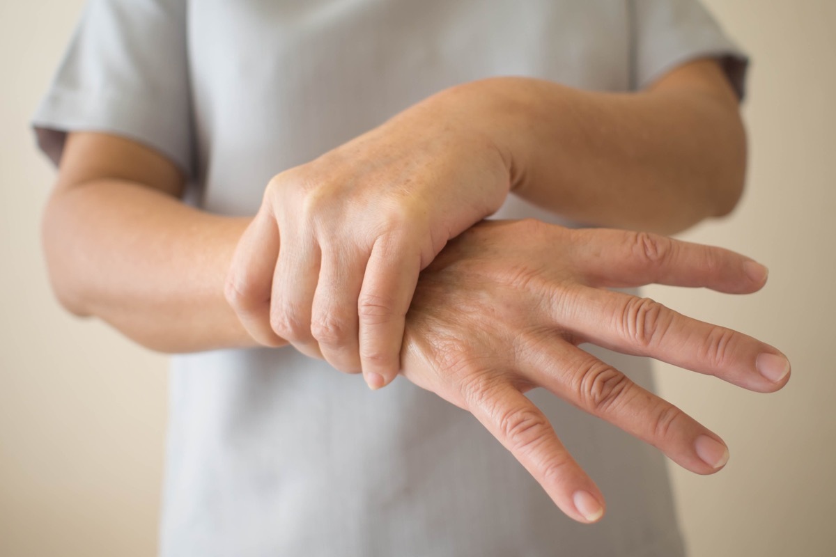 Person holding their hand while having a tremor