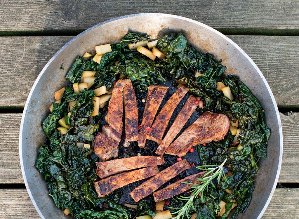 Paleo meal with steak on a bed of greens