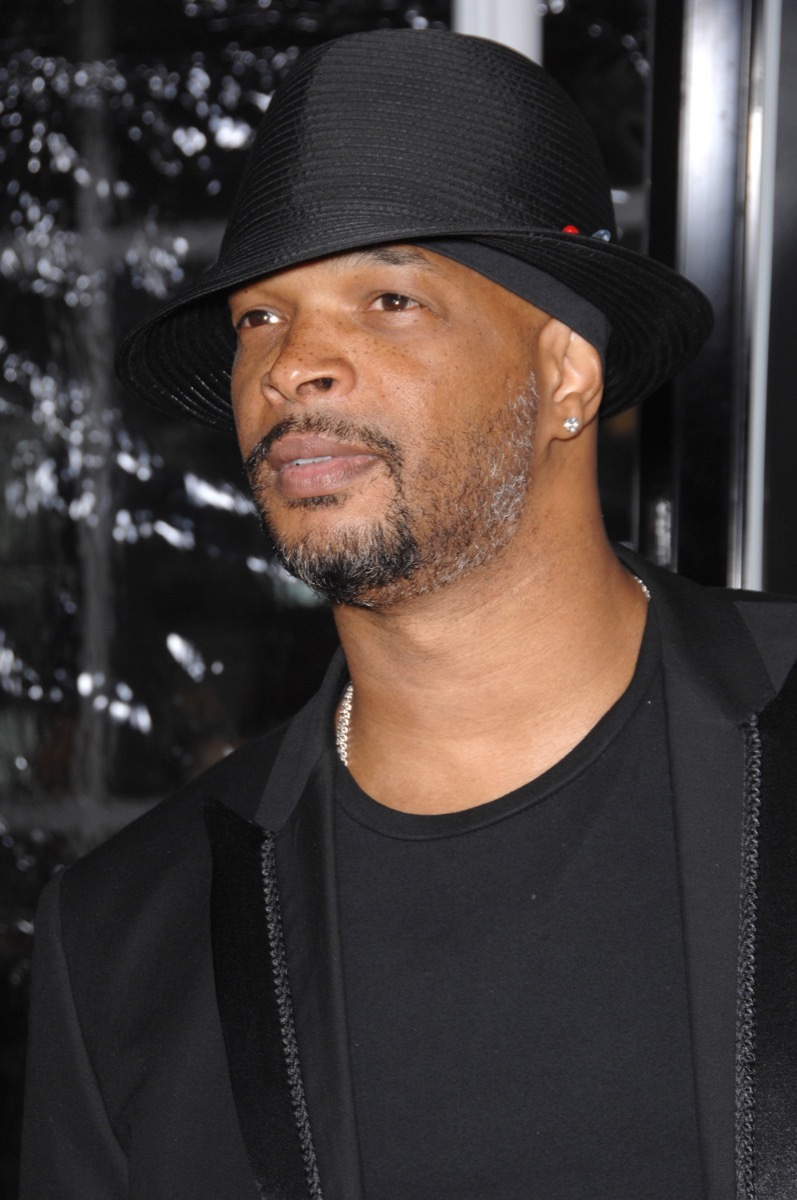 Damon Wayans wears black hat and black jacket and shirt, celebrity grandparent