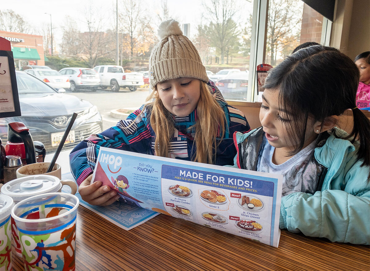 two kids looking at ihop menu