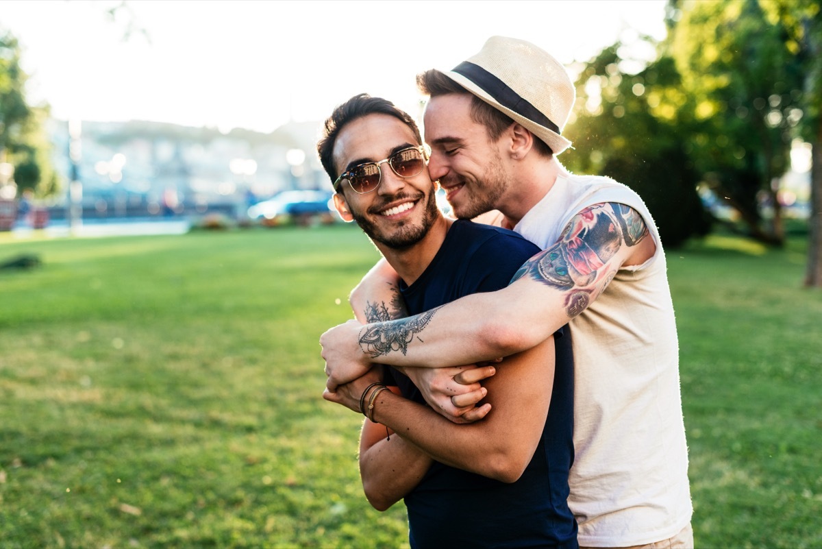 couple spending time together hugging on a park date outside