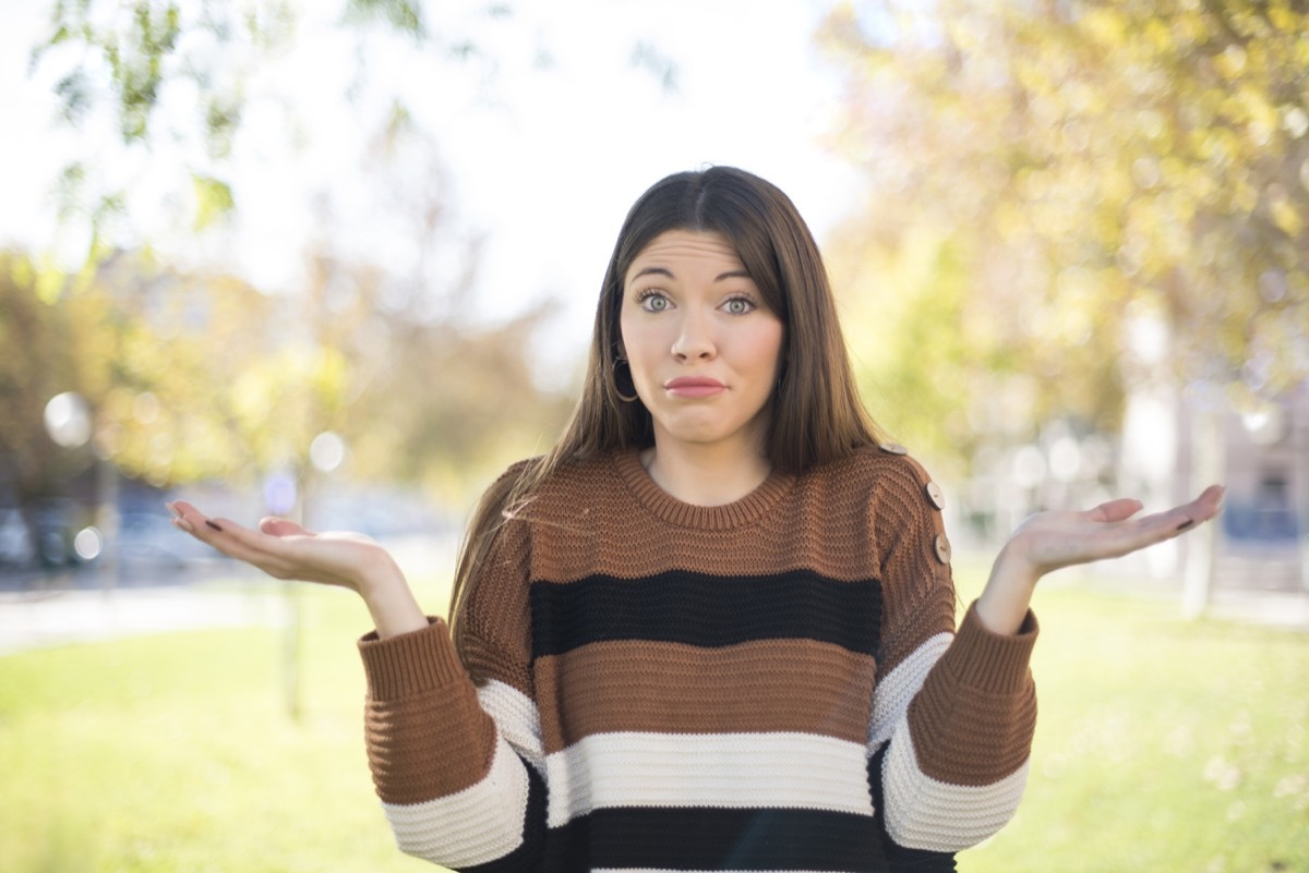 woman doing i don't know gesture with hands