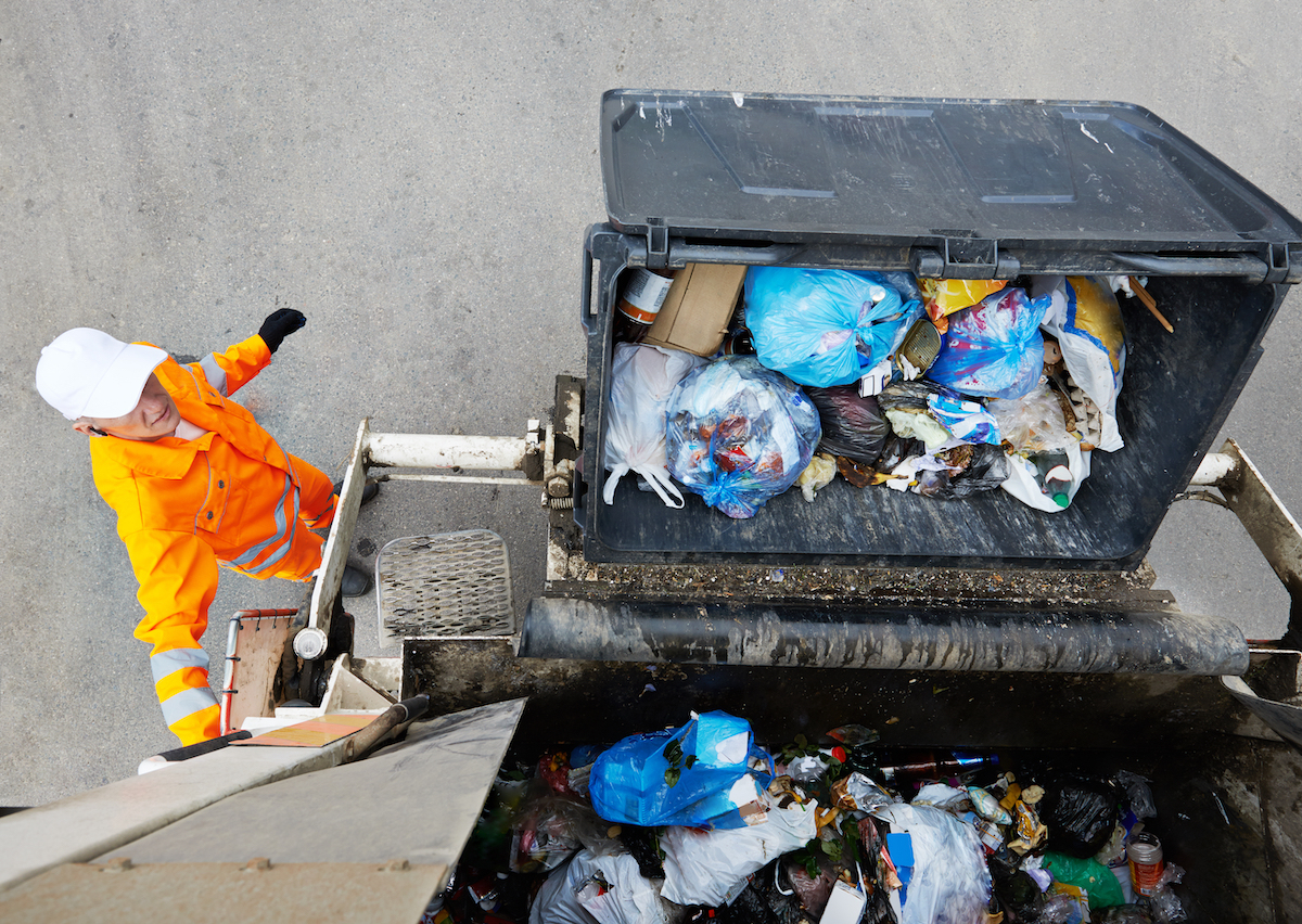 Garbage collector on garbage truck