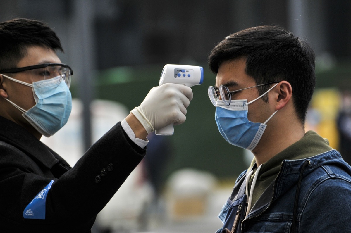 People lined up for temperature checks before entering the Chunxi Road, downtown mall in Chengdu, China