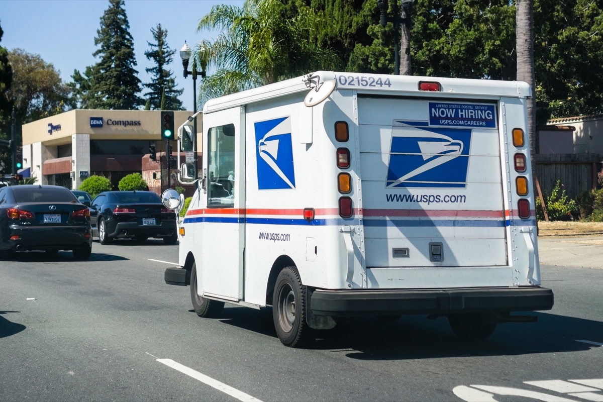 USPS vehicle driving on a busy street in south San Francisco bay area