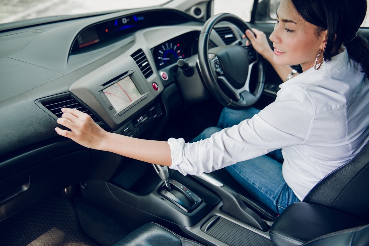 woman adjusting air conditioning rental car