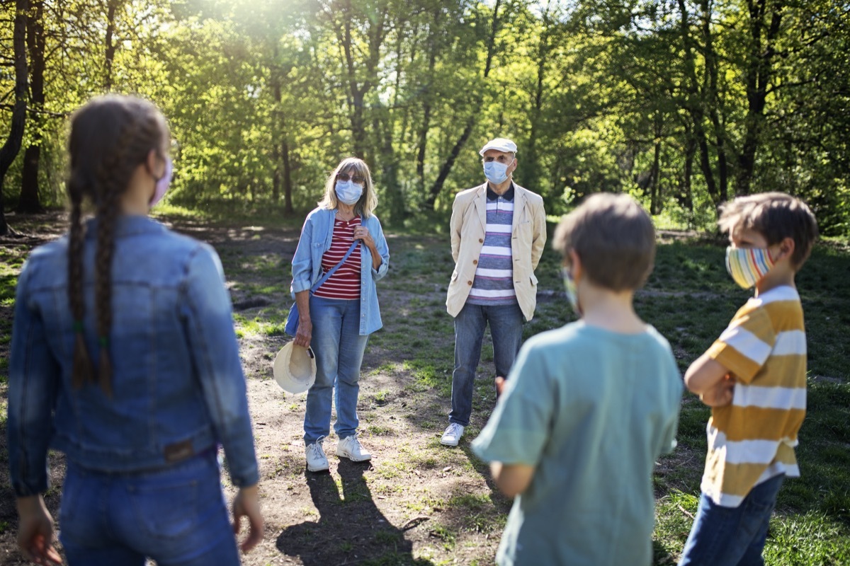 likely to give you Covid Grandparents and grandchildren meeting in the park. The COVID-19 pandemic restrictions are loosened and the seniors are allowed to see their grandchildren with keeping distance and wearing masks. BMPCC4K, raw, Q0