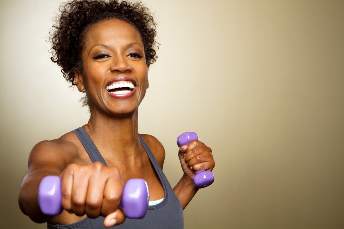 Woman working out lifting weights, home hazards