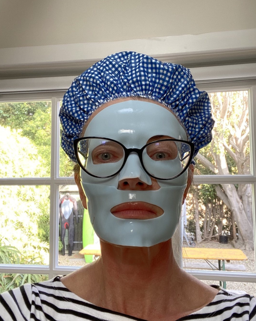 Paulina Porizkova wearing a sheet mask and shower cap in an Instagram selfie