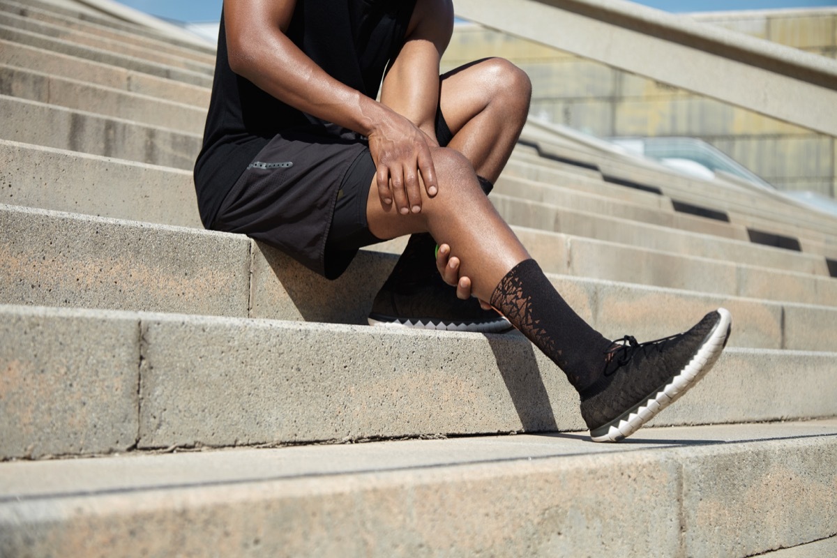 Man gripping his leg in pain after a run or jog