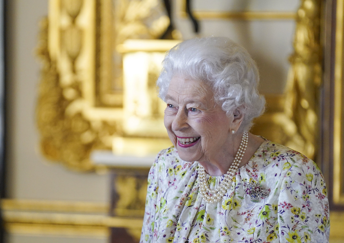 Queen Elizabeth viewing artifacts from Halcyon Days to celebrate the company's 70th anniversary in March 2022