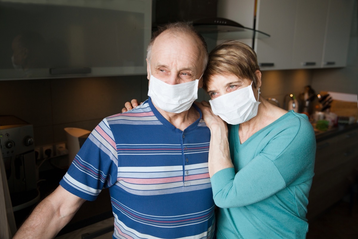 Seniors couple wearing medical face mask and recovery from the illness in home. quarantine. health