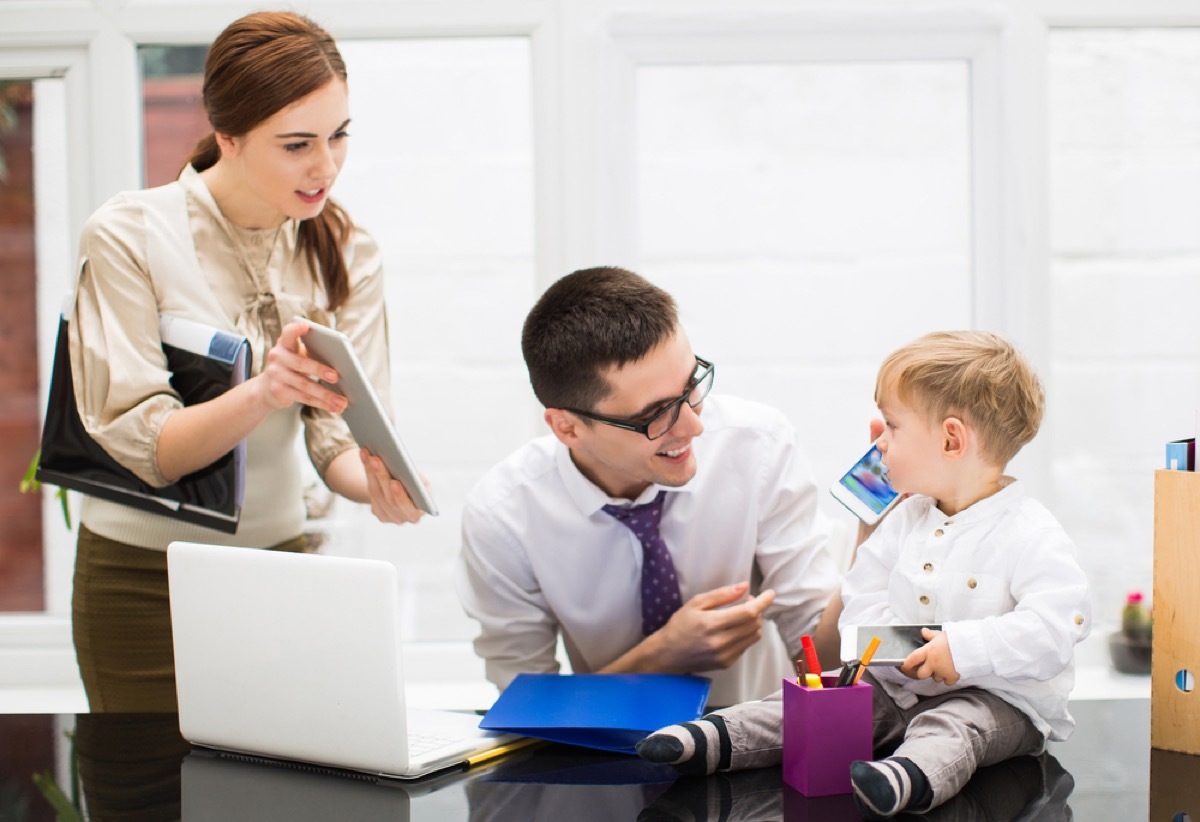 mom and dad working with baby, ways parenting has changed.