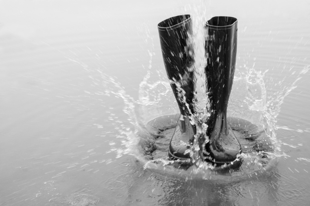 Rubber boots in a puddle