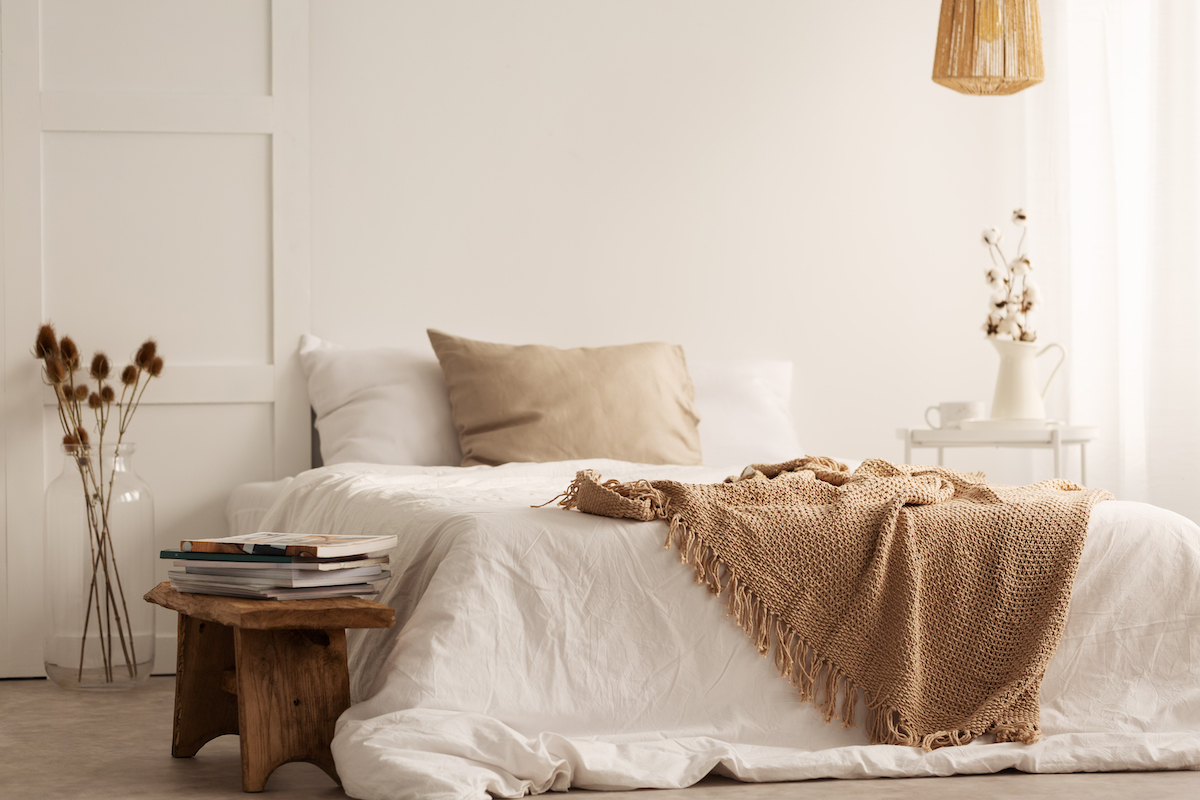 A nicely decorated bedroom done in neutral colors