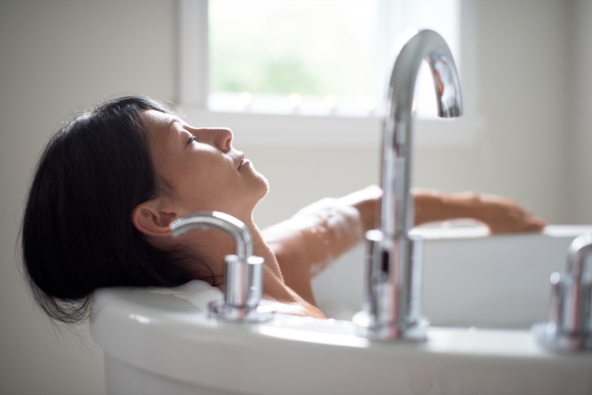 close up of middle aged white woman taking a bath