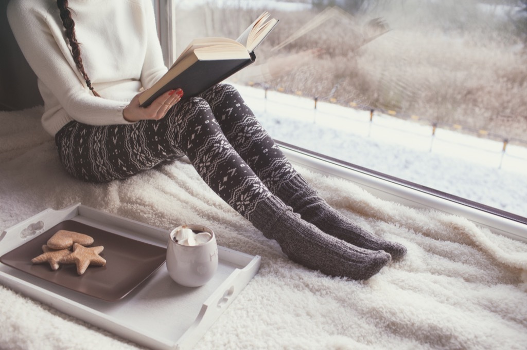 woman cozy reading in her bed stay sharp