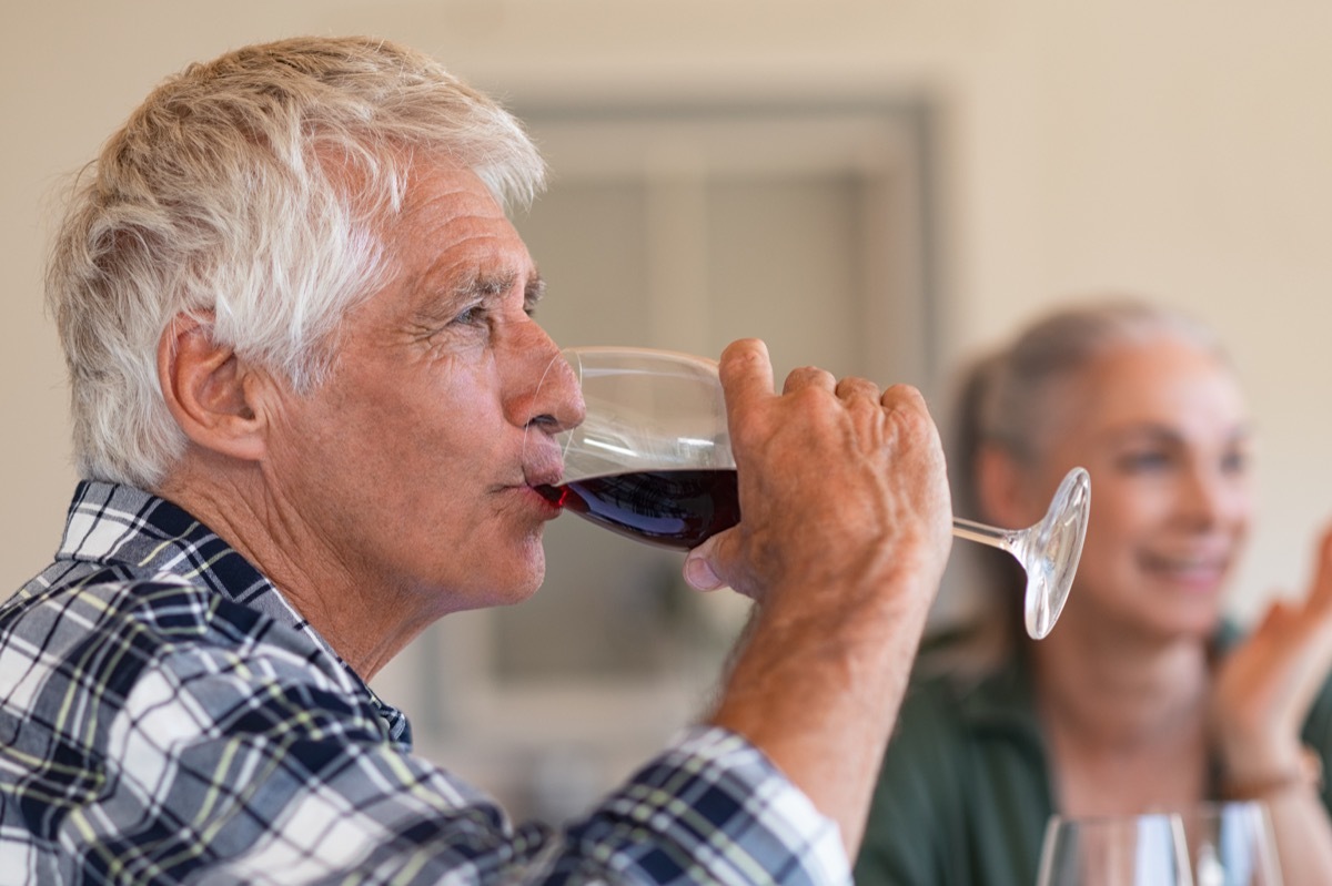 Mature man drinking a glass of red wine