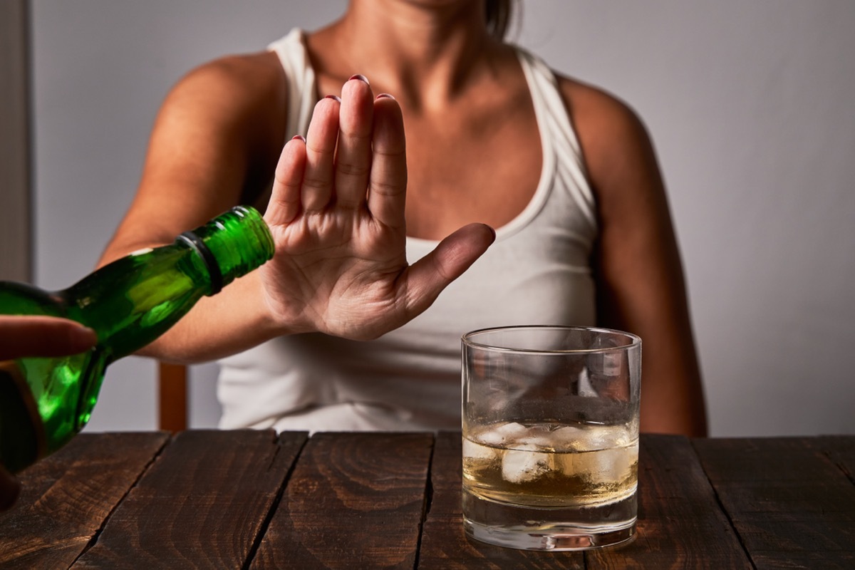 Woman refusing a drink.