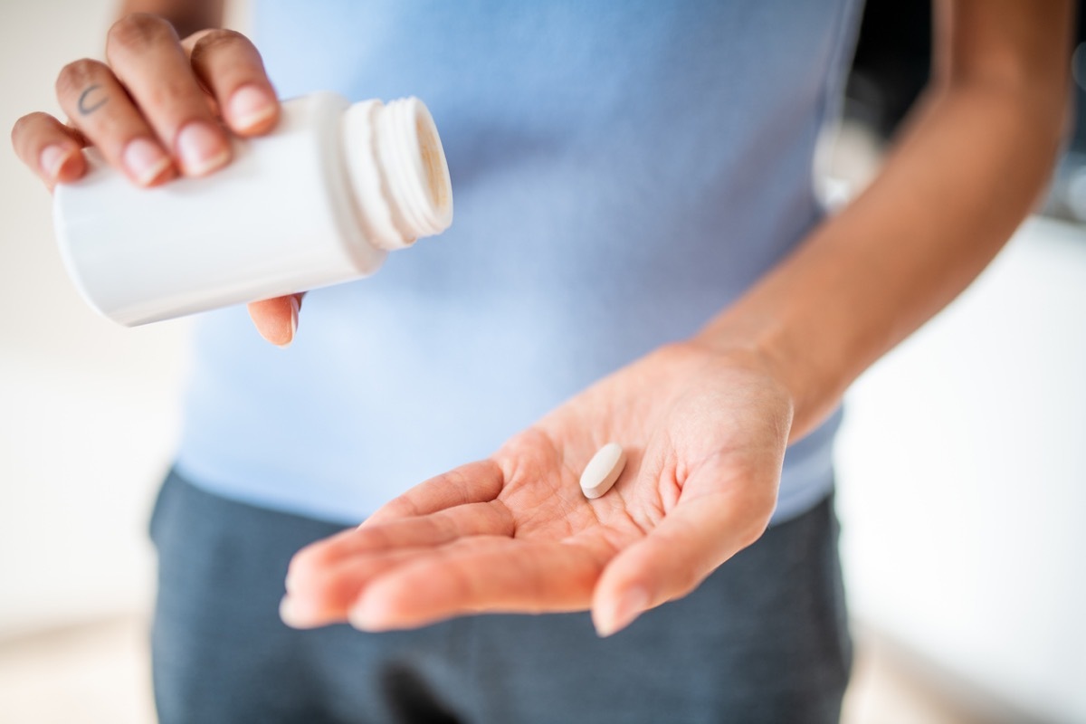 woman taking supplement