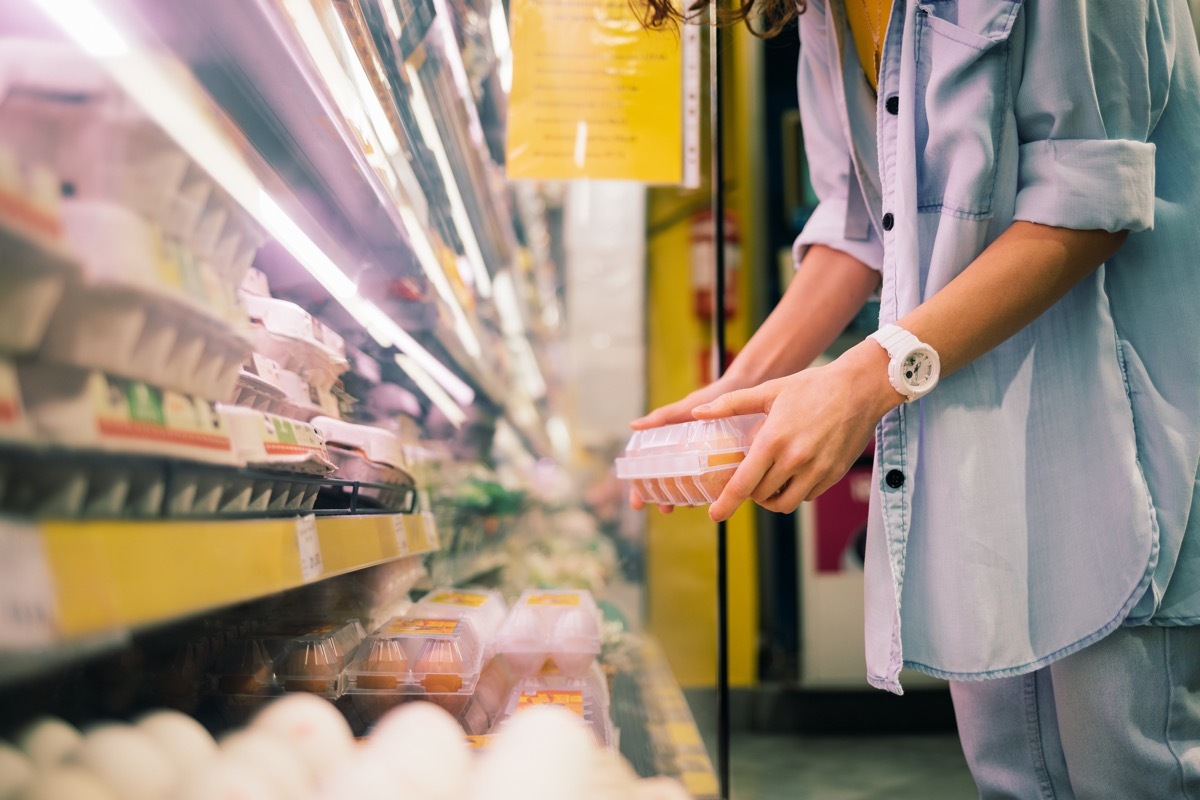 Woman buys chicken eggs in the store