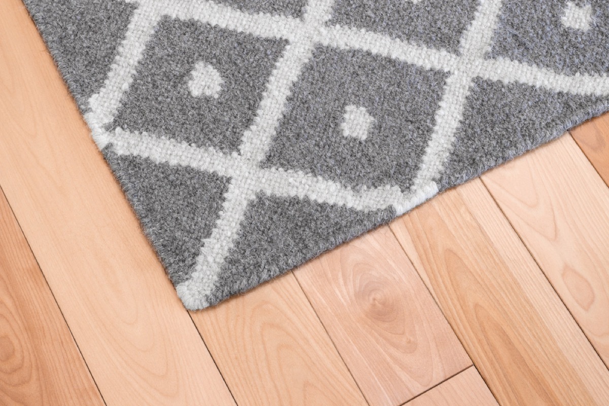 gray rug on hardwood floor, fire prevention tips