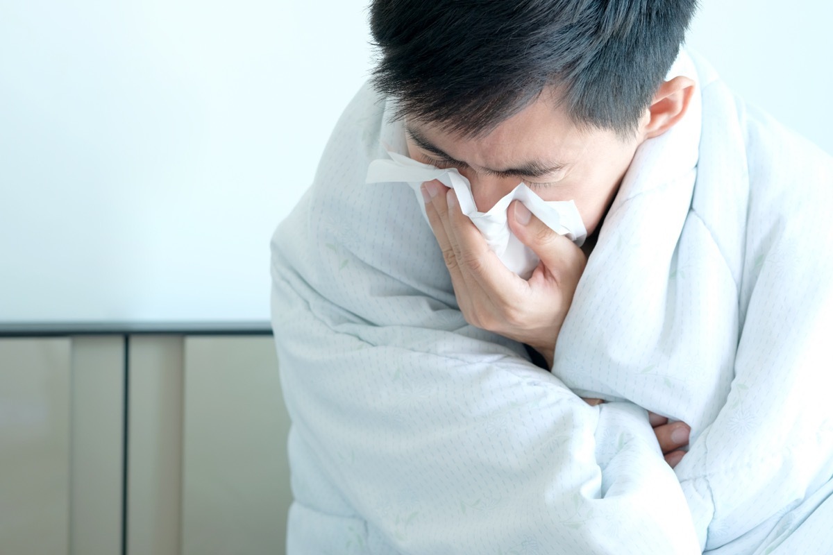 Man blowing his nose sick