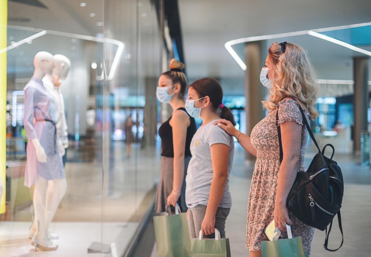 Family shopping at the mall during COVID-19 pandemic. They wears a protective mask to protect from coronavirus COVID-19.