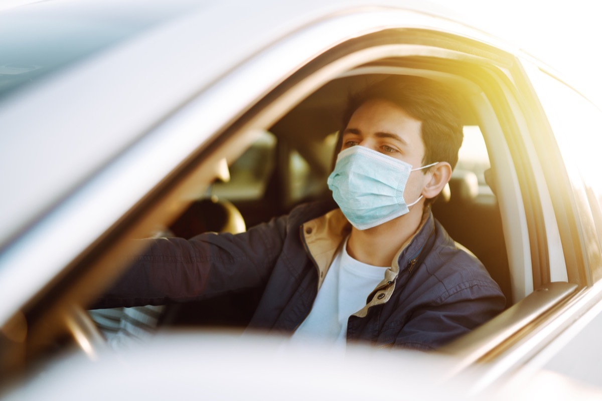 Man wearing mask in car