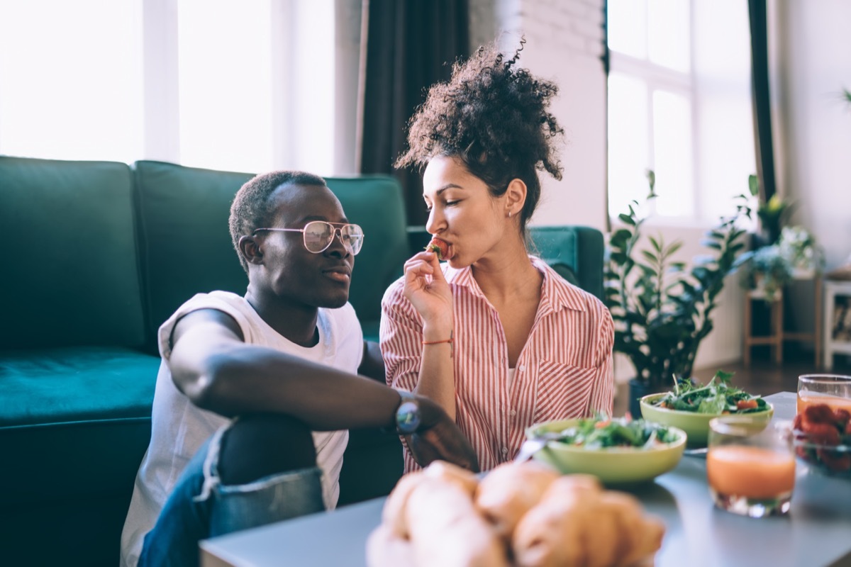 Couple eating on floor together